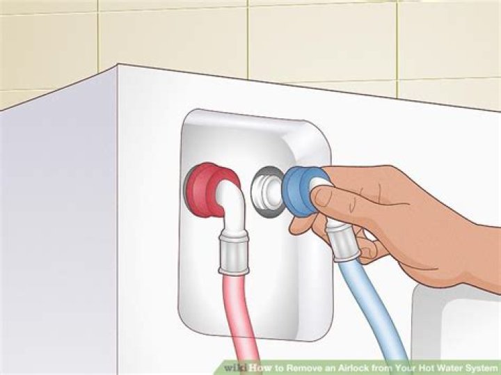 How do I clear an airlock in my hot water system