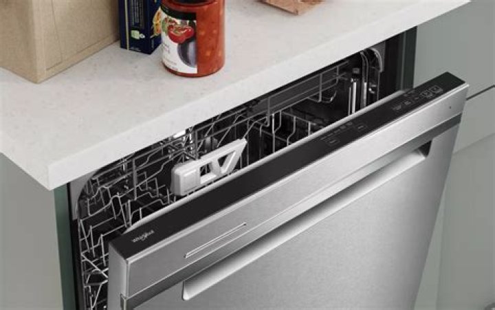How do I open the door on my Whirlpool dishwasher