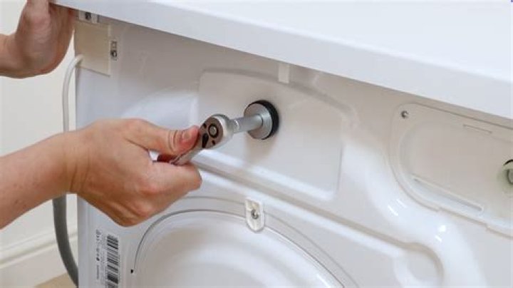 How do you remove transport bolts from a washing machine