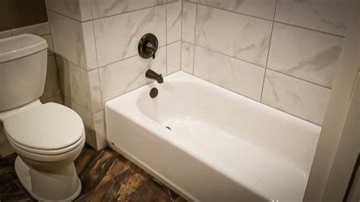 How do you tile around a bathtub flange