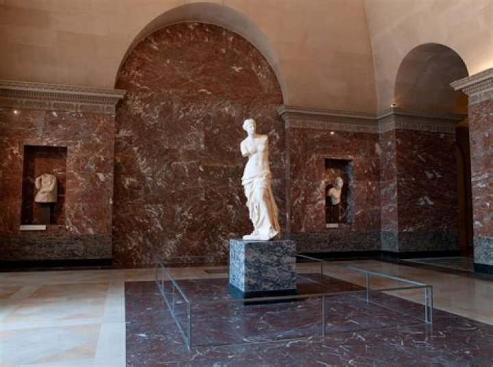 Why is the statue of Aphrodite of Melos attributed to the goddess of love Aphrodite